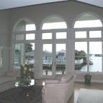 View of Family Room overlooking rear Deck and waterway.